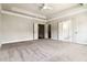 Spacious main bedroom featuring neutral carpet, ceiling fan, and ensuite bathroom and closet at 510 Suwanee Pass Ln, Suwanee, GA 30024