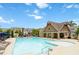 Community pool with surrounding seating and amenities under a blue sky at 510 Suwanee Pass Ln, Suwanee, GA 30024
