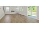 Bright living room featuring hardwood floors, a modern fireplace, and sliding glass doors to the backyard at 7139 Brushwood Bend - Lot 42, Lithonia, GA 30058