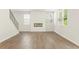 Spacious living room featuring hardwood floors, a modern fireplace, and abundant natural light at 7139 Brushwood Bend - Lot 42, Lithonia, GA 30058