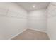 Spacious walk-in closet with carpeted floors and metal racks for organized storage at 7139 Brushwood Bend - Lot 42, Lithonia, GA 30058