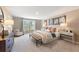 Comfortable bedroom with plush bedding, a cushioned bench, and serene outdoor views at 7145 Brushwood Bend - Lot 41, Lithonia, GA 30058
