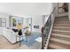 Cozy living room featuring a white sofa, modern fireplace, stylish decor, and staircase at 7145 Brushwood Bend - Lot 41, Lithonia, GA 30058