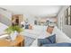 Bright and airy living area featuring a large white sectional, modern decor, and staircase access at 7145 Brushwood Bend - Lot 41, Lithonia, GA 30058