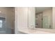 Bathroom vanity with stylish mirror and tile in shower with glass doors at 1903 Deco Dr, Kennesaw, GA 30144