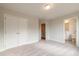 Bedroom featuring neutral walls, carpet and access to bathroom and closet at 1903 Deco Dr, Kennesaw, GA 30144