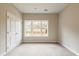 Bright bedroom with carpeted floors, large window, and a double door closet at 1903 Deco Dr, Kennesaw, GA 30144