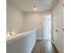 Well lit hallway with wood floors that leads to an open doorway and bright bedroom at 1903 Deco Dr, Kennesaw, GA 30144