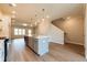 Open-concept kitchen with island, stainless appliances, and adjacent staircase at 1903 Deco Dr, Kennesaw, GA 30144