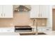 A close-up view of a stainless steel range and sink in a modern kitchen at 1903 Deco Dr, Kennesaw, GA 30144