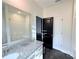 Bathroom with granite countertop vanity and shower, black and white doors, and updated fixtures at 3076 Quantum Ln, Atlanta, GA 30341