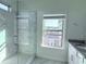 Modern bathroom featuring a glass enclosed shower and neighborhood views at 3076 Quantum Ln, Atlanta, GA 30341
