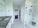 Elegant bathroom featuring dual sinks, granite countertop, and glass walk-in shower at 3076 Quantum Ln, Atlanta, GA 30341