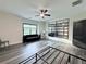 Comfortable bedroom includes ceiling fan, and a stylish wall mirror above the light gray wide plank flooring at 3076 Quantum Ln, Atlanta, GA 30341