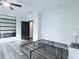 Spacious bedroom features ceiling fan, light gray flooring, black door, and a stylish wall mirror at 3076 Quantum Ln, Atlanta, GA 30341