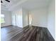 Bright bedroom showcasing tray ceiling, dark floors, and ensuite bathroom at 3076 Quantum Ln, Atlanta, GA 30341