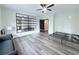 Spacious bedroom features a ceiling fan, and a stylish wall mirror above the light gray wide plank flooring at 3076 Quantum Ln, Atlanta, GA 30341