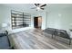 Bright bedroom has ceiling fan, and a stylish wall mirror above the light gray wide plank flooring at 3076 Quantum Ln, Atlanta, GA 30341