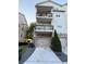Rear exterior view of house with two-car garage and multiple balconies at 3076 Quantum Ln, Atlanta, GA 30341