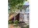 View of stacked stone and vinyl exterior with wooden staircase and small door at 3076 Quantum Ln, Atlanta, GA 30341