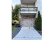 Two-car garage and driveway with balcony above in a well-maintained neighborhood at 3076 Quantum Ln, Atlanta, GA 30341