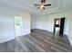 Large primary bedroom featuring tray ceiling, grey-tone wood flooring and ensuite bath at 3076 Quantum Ln, Atlanta, GA 30341