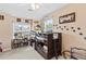 A whimsical bedroom features a loft bed adorned with dinosaur-themed decor and ample natural light at 4545 Evandale Way, Cumming, GA 30040