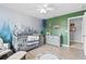 bedroom design featuring forest mural and a dark green accent wall at 4545 Evandale Way, Cumming, GA 30040