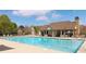 Large community pool with lounge chairs, tables, and outdoor seating area under a covered patio at 4545 Evandale Way, Cumming, GA 30040