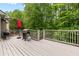 An elevated wooden deck with green foliage in the background, perfect for outdoor entertaining and relaxation at 4545 Evandale Way, Cumming, GA 30040