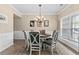 Elegant dining room with a chandelier, wainscoting, and a large window for natural light at 4545 Evandale Way, Cumming, GA 30040