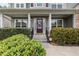 Inviting front porch with a decorative wreath on the front door and manicured shrubbery at 4545 Evandale Way, Cumming, GA 30040