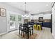 Eat-in kitchen features updated appliances, kitchen island, modern chandelier, and French doors at 4545 Evandale Way, Cumming, GA 30040