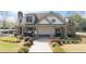 Exterior of the pool house featuring stone accents, an outdoor grilling area, and lush landscaping at 4545 Evandale Way, Cumming, GA 30040