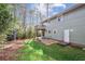 Backyard featuring an elevated deck, a door to the basement, and luscious greenery at 875 Waterbrook Ct, Roswell, GA 30076