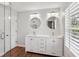 Bright bathroom features double vanity with quartz countertops and modern lighting at 875 Waterbrook Ct, Roswell, GA 30076