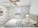 Bright bedroom featuring neutral walls and decor, natural light and a ceiling fan at 875 Waterbrook Ct, Roswell, GA 30076