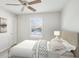 Bright bedroom with a large window and neutral decor at 875 Waterbrook Ct, Roswell, GA 30076