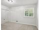 Bright bedroom with a mirrored closet, and neutral carpet at 875 Waterbrook Ct, Roswell, GA 30076