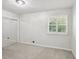 Cozy bedroom with neutral walls, carpet and a closet with mirrored doors at 875 Waterbrook Ct, Roswell, GA 30076