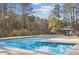 Community pool featuring a large area for swimming, a small wading pool, and a shaded seating area at 875 Waterbrook Ct, Roswell, GA 30076