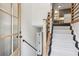 Entryway with modern wooden door, carpeted stairs, and railing at 875 Waterbrook Ct, Roswell, GA 30076