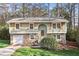 Charming split-level home with stone accents, attached garage, and well-maintained front yard at 875 Waterbrook Ct, Roswell, GA 30076
