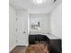 Bright home office with natural light and a dark L-shaped desk with built-in storage at 875 Waterbrook Ct, Roswell, GA 30076