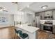 Open-concept kitchen with stainless steel appliances, breakfast bar, and a view of the living area at 875 Waterbrook Ct, Roswell, GA 30076