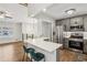 Updated kitchen features stainless steel appliances, white quartz counters, gray cabinetry and bar seating at 875 Waterbrook Ct, Roswell, GA 30076