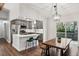 Open concept kitchen and dining area with stainless steel appliances and access to back deck at 875 Waterbrook Ct, Roswell, GA 30076