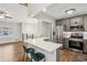 Open concept kitchen with a large quartz breakfast bar and stainless steel appliances at 875 Waterbrook Ct, Roswell, GA 30076