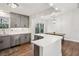 Modern kitchen with gray cabinets, stainless steel appliances, quartz counters, and eat-in area at 875 Waterbrook Ct, Roswell, GA 30076