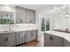 Modern kitchen features stainless steel appliances, gray cabinets, quartz counters, and eat-in area at 875 Waterbrook Ct, Roswell, GA 30076